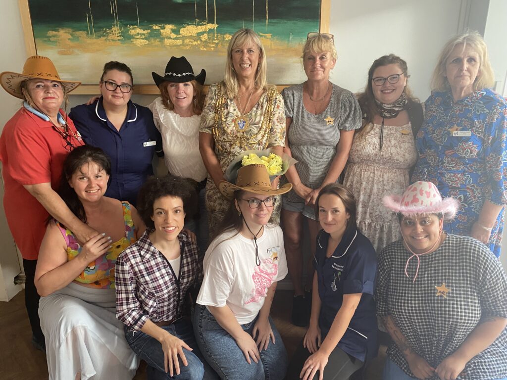 Staff from Highbury House taking a group photo with Cllr Folwer